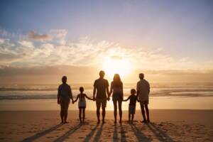 family of six standing on the beach